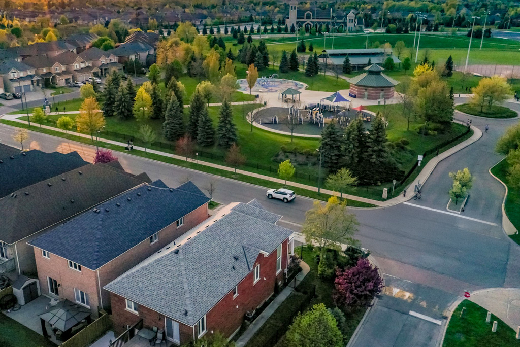 Aerial view of a neighborhood featuring parks, schools, and shops, highlighting the variety of local amenities that contribute to long-term property value.
